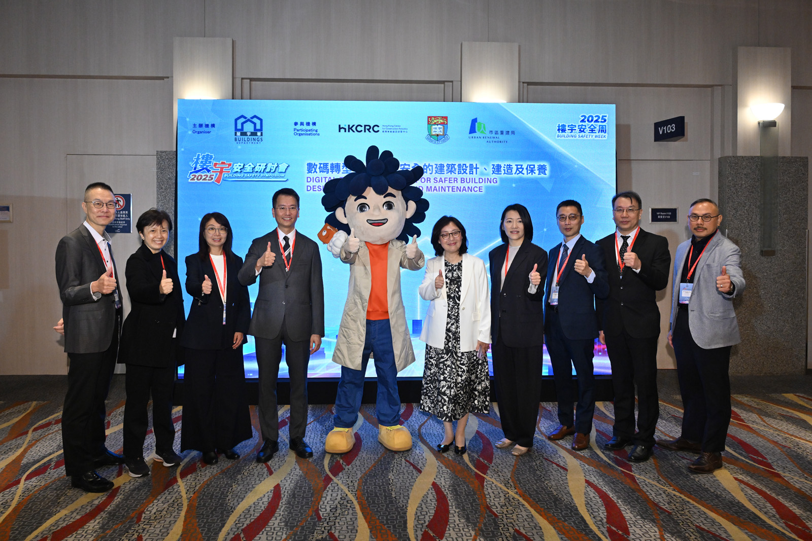 The Buildings Department held the Building Safety Symposium at the Hong Kong Convention and Exhibition Centre today (November 14). Photo shows the Secretary for Development, Ms Bernadette Linn (fifth right); the Director of Buildings, Mr Ho Chun-hung (fourth left); the Deputy Director of Buildings, Ms Pelene Ng (fourth right); and other Assistant Directors of Buildings with mascots of the Buildings Department Ah Build and Ah Ding (Building Genie) at the venue of the symposium.